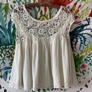 ADorable sheer top with crochet detail.